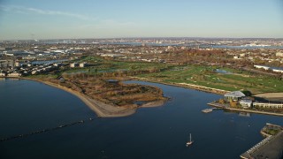 AX118_218E - 5.5K aerial stock footage of Waterfront Golf Course at sunrise in Jersey City, New Jersey