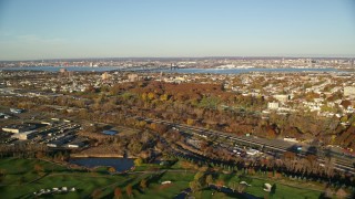 AX118_220E - 5.5K aerial stock footage of freeway and cemetery at sunrise in Jersey City, New Jersey