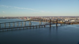 AX118_223E - 5.5K aerial stock footage of Newark Bay Bridge and Lehigh Valley Bridge at sunrise in Newark, New Jersey
