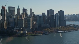 AX119_015E - 5.5K aerial stock footage of Battery Park and skyscrapers in Autumn, Lower Manhattan, New York City