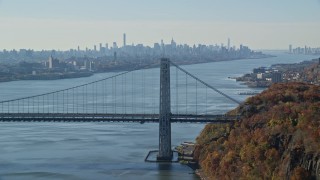 AX119_050 - 5.5K aerial stock footage of the Midtown skyline, flyby George Washington Bridge in Autumn, New York City