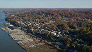 AX119_074E - 5.5K aerial stock footage video of riverfront homes in Hastings on Hudson, New York, in Autumn