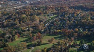 AX119_085 - 5.5K aerial stock footage of mansions and small town homes in Autumn, Tarrytown, New York