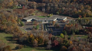 AX119_106 - 5.5K aerial stock footage of circling around an office building in Autumn, Sleepy Hollow, New York
