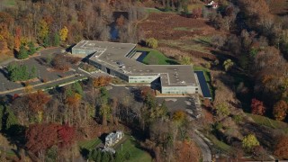 AX119_107 - 5.5K aerial stock footage orbit an office building in Autumn, Sleepy Hollow, New York