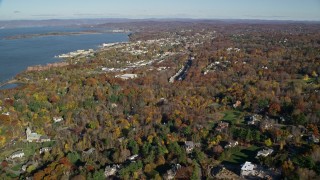 AX119_111E - 5.5K aerial stock footage of a small riverfront town in Autumn, Briarcliff Manor and Ossining, New York