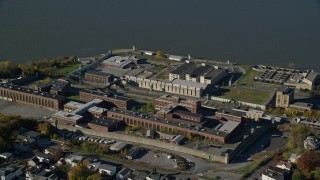 AX119_114E - 5.5K aerial stock footage of orbiting Sing Sing Prison in Autumn, Ossining, New York
