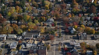 AX119_130 - 5.5K aerial stock footage of homes near a small town street intersection in Autumn, Croton on Hudson, New York