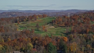 AX119_133 - 5.5K aerial stock footage of a hillside golf course in Autumn, Croton on Hudson, New York