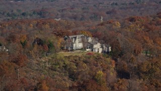 AX119_134 - 5.5K aerial stock footage orbit an isolated hilltop mansion in Autumn, Croton on Hudson, New York