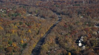 AX119_135 - 5.5K aerial stock footage of a tree-lined highway in Autumn, Croton on Hudson, New York