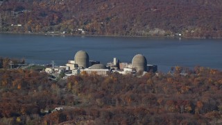 AX119_143E - 5.5K aerial stock footage of the riverfront Indian Point Nuclear Plant in Autumn, Buchanan, New York