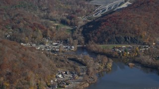 AX119_148 - 5.5K aerial stock footage orbit inlet and small town industrial shops in Autumn, Peekskill, New York