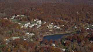 AX119_156E - 5.5K aerial stock footage of condominium complexes overlooking pond in Autumn, Fort Montgomery, New York