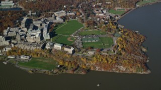 AX119_184 - 5.5K aerial stock footage of flying away from West Point Military Academy in Autumn, West Point, New York