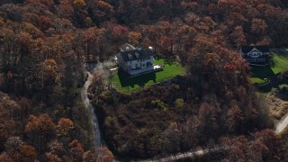 AX119_188E - 5.5K aerial stock footage of hilltop homes in Autumn, Garrison, New York
