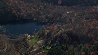 AX119_190 - 5.5K aerial stock footage of lakeside homes in Autumn, Garrison, New York