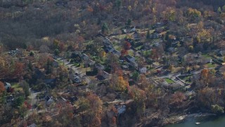 AX119_197 - 5.5K aerial stock footage of a lakeside neighborhood in Autumn, Mohegan Lake, New York