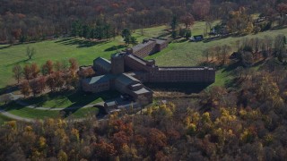AX119_198 - 5.5K aerial stock footage video of a secluded hospital in Autumn, Mohegan Lake, New York