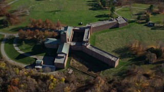 AX119_199 - 5.5K aerial stock footage orbit a secluded hospital in Autumn, Mohegan Lake, New York