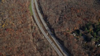 AX119_200 - 5.5K aerial stock footage of forest highway in Autumn, Yorktown Heights, New York