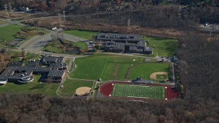 AX119_201 - 5.5K aerial stock footage of middle and high schools in Autumn, Yorktown Heights, New York