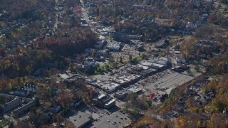 AX119_210E - 5.5K aerial stock footage of a small town shopping center in Autumn, Mt Kisco, New York