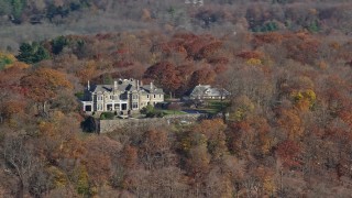 AX119_214 - 5.5K aerial stock footage of an isolated hilltop mansion in Autumn, Mt Kisco, New York