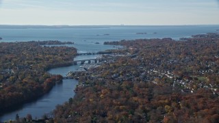 AX119_229E - 5.5K aerial stock footage of a small town community and bridges over river in Autumn, Greenwich, Connecticut