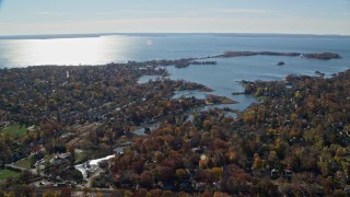 AX119_233 - 5.5K stock footage aerial video of a small town waterfront neighborhood in Autumn, Greenwich, Connecticut