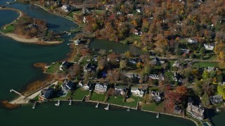 AX119_234 - 5.5K aerial stock footage orbiting upscale waterfront homes in Autumn, Greenwich, Connecticut