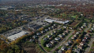 AX119_248 - 5.5K aerial stock footage of a suburban neighborhood and strip mall in Autumn, Woodbury, New York