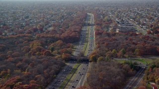 AX120_003E - 5.5K aerial stock footage of a freeway in Autumn, Farmingdale, New York