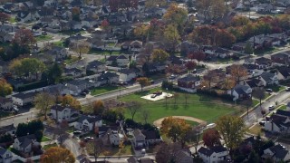 AX120_007 - 5.5K aerial stock footage of suburban neighborhoods in Autumn, Massapequa, New York