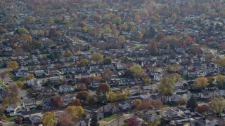 AX120_008E - 5.5K aerial stock footage of suburban neighborhoods in Autumn, Massapequa, New York