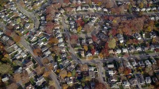 AX120_022E - 5.5K aerial stock footage bird's eye view of a suburban neighborhood in Autumn, Merrick, New York