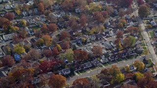 AX120_025E - 5.5K aerial stock footage of rows of suburban homes in Autumn, Uniondale, New York