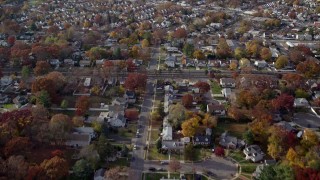 AX120_031E - 5.5K aerial stock footage fly over golf course and suburbs in Autumn, West Hempstead, New York