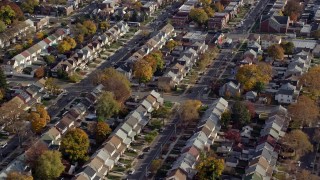 AX120_043E - 5.5K stock footage aerial video of orbiting suburban tract homes in Autumn, Queens Village, Queens, New York City