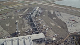 AX120_065 - 5.5K aerial stock footage orbit airliners at terminals at John F Kennedy International Airport, New York