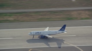 AX120_066E - 5.5K aerial stock footage track a commercial jet taking off from JFK Airport, New York