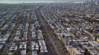 AX120_081 - 5.5K aerial stock footage of tree-lined city street through Brooklyn in Autumn, New York City