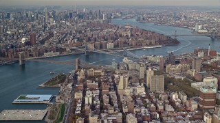 AX120_091 - 5.5K aerial stock footage of Brooklyn and Manhattan Bridges in Autumn, New York City