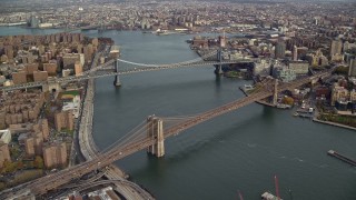 AX120_128 - 5.5K aerial stock footage of approaching the Manhattan and Brooklyn Bridges in New York City