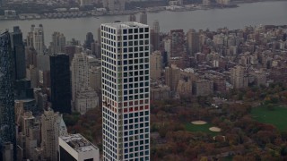AX120_162E - 5.5K aerial stock footage orbit top of 432 Park Avenue in Midtown in Autumn, New York City