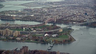 AX120_200E - 5.5K aerial stock footage of Robert F Kennedy Bridge and Hell Gate Bridge on Wards Island, New York City