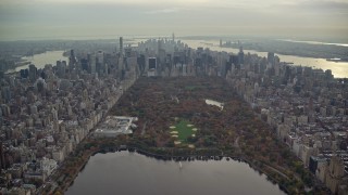 AX120_210E - 5.5K aerial stock footage fly over Central Park toward Midtown in Autumn, New York City