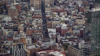 AX120_244 - 5.5K aerial stock footage orbit apartment buildings and busy street In Soho, New York City
