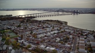 AX120_269E - 5.5K stock footage aerial video of suburban homes and row houses near bridges in Autumn, Jersey City, New Jersey