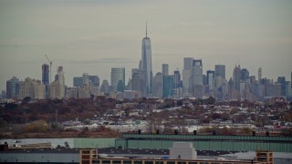 AX120_274 - 5.5K aerial stock footage of Freedom Tower and Lower Manhattan skyline seen from Jersey City in Autumn